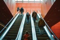 people ascending escalator leading to upperlevel theater auditoriums Royalty Free Stock Photo