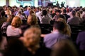 People attend a conference in a big hall