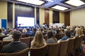 People Attending Business Conference Sitting in Front of the Host Royalty Free Stock Photo