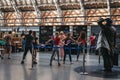 People attending a retro dance event inside St. Pancras Station, London, UK.