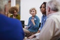 People Attending Self Help Therapy Group Meeting In Community Center