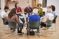 People Attending Self Help Therapy Group Meeting In Community Center