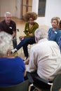 People Attending Self Help Therapy Group Meeting In Community Center Royalty Free Stock Photo