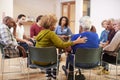 People Attending Self Help Therapy Group Meeting In Community Center Royalty Free Stock Photo