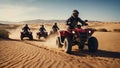 People on ATVs ride through the sunny desert