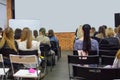 People in auditory during presentation or seminar. Teenagers or young men and women at university lecture or seminar. Back side