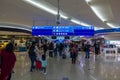 People with baggage walking in Airport duty free area