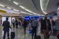 People with baggage walking in Airport duty free area