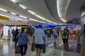 People with baggage walking in Airport duty free area