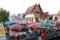 People in Bangkok wear face masks shopping at local weekly market