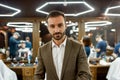 People at barbershop. Young handsome bearded man wearing white shirt and jacket looking at camera, visiting barber shop Royalty Free Stock Photo