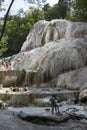 People bathing in Bagni San Filippo natural thermal pools