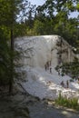 People bathing in Bagni San Filippo natural thermal pools