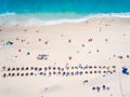 People bathing in the sun, swimming and playing games on the beach. Tourists on the sand beach in Kefalonia island, Greece