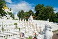 People bathing and washing on the riverbank of Irrawaddy River, next to chinthe statues, Burma