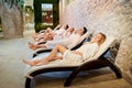 People in bathrobes are resting in the spa salon. Royalty Free Stock Photo