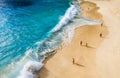 People on the beach on Bali, Indonesia. Vacation and adventure. Beach and large waves. Top view from drone at beach, azure sea and Royalty Free Stock Photo