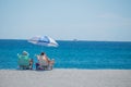 2 people in beach chairs on the sand on a beach in Florida Royalty Free Stock Photo