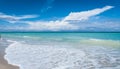 People on a beach relaxing on holidays, resort beaches, cloudscape on horizon. Travel and beach holidays. Royalty Free Stock Photo