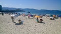 People at the beach in Sanxenxo Spain with Madama de Silgar at background