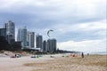 People on the beach on storm day getting ready to kite surf with one kite in the air - The Gold Coast Queensland Australia 7 4 201