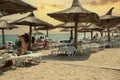 Constanta, Romania May 24, 2014: people on the beach, sunset - straw umbrellas