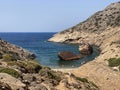 People on the beach visiting Shipwreck Olympia boat in Amorgos island during summer holidays, at the coastal rocky area, , Royalty Free Stock Photo