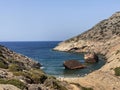 People on the beach visiting Shipwreck Olympia boat in Amorgos island during summer holidays, at the coastal rocky area, , Royalty Free Stock Photo