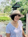 Outdoors close up portrait of girl smiling or Asian woman smiling in the park and looking at camera Royalty Free Stock Photo