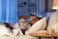 sleepless african woman lying in bed at night