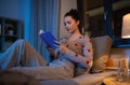 teenage girl reading book in bed at home Royalty Free Stock Photo