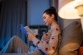 teenage girl reading book in bed at home Royalty Free Stock Photo