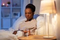 african woman drinking water in bed at night Royalty Free Stock Photo