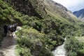 Tourists starting the hike on the Inca trail to Machu Picchu through the mountains next to Urubamba river Royalty Free Stock Photo