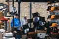 People behind hats on sale at stall inside Spitalfields Market, London, UK Royalty Free Stock Photo