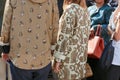 People with beige and white clothing fabric patterns before Stella Jean fashion show, Milan Fashion Week