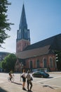 people and bicycler on street near church Royalty Free Stock Photo