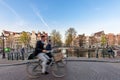 People bicycling through city streets on a beautiful sumer day i