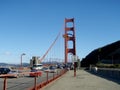 People bike on Art Deco Walkway and cars drive road on the Golden Gate Bridge