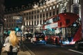 People, black cabs and a bus on Regent Street in the evening, London, UK