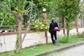 People black dress are mowers roadside close house