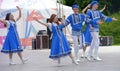 People in blue Russian national costumes dance at the International Festival Ã¢â¬ÅHave Contact