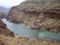 People Prepare to take a Raft boat tour in a canyon