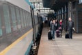 People board train on Prague Main station