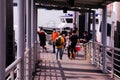 People boarding ferry to St John`s Island at Marina South Pier, having their temperature taken by staff Royalty Free Stock Photo