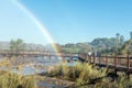 People on boardwalk next to rainbow at the Augrabies Falls