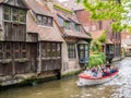 People in boat on Dijver canal and historic houses in Bruges, Belgium Royalty Free Stock Photo