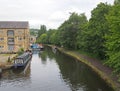 People and boats around the wharf are on the canal in sowerby bridge