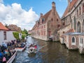 People, boats and Bakkersrei canal near Saint John`s Hospital in Bruges, Belgium