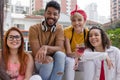 Cheerful young friends having weekend fun at cafe bar outdoor. S